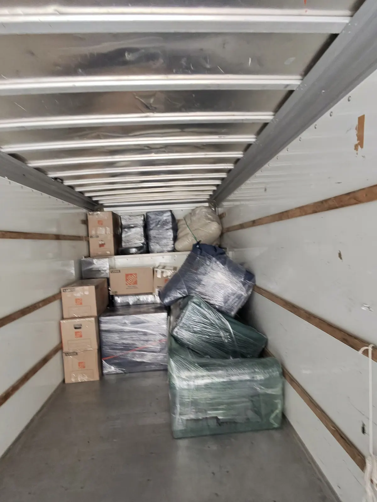 Boxes and wrapped furniture loaded inside an ASAP Moving truck in Avon, Ohio.