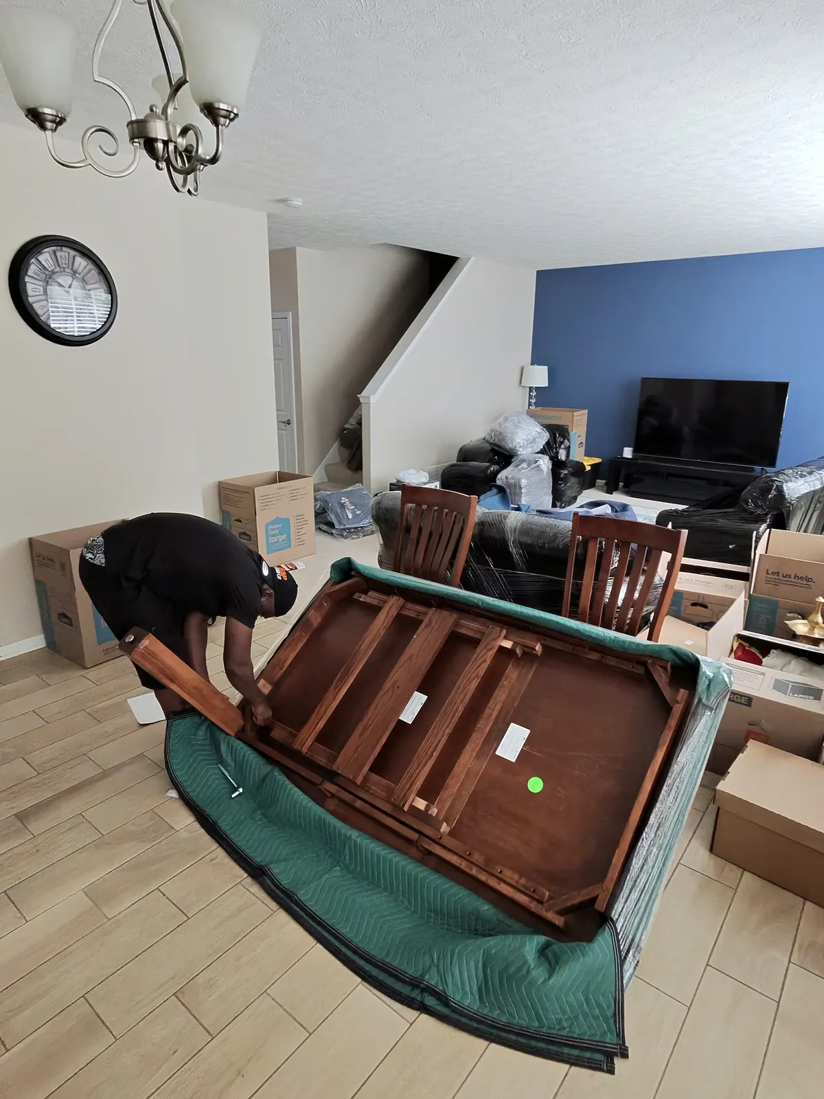 ASAP Moving crew member working on an upside-down table resting on a moving blanket in Avon Lake, Ohio.