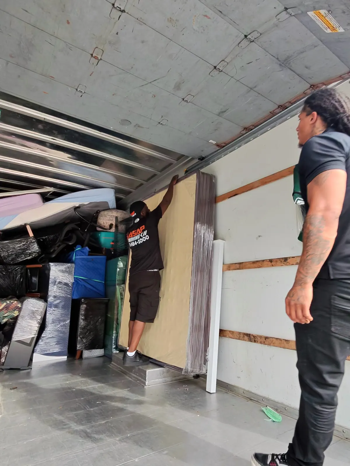 ASAP Moving crew members inside a truck with household items loaded along the side in Solon, Ohio.